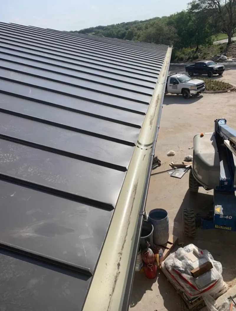 Standing seam panel and gutter detail on a metal roofing jobsite in Oklahoma City